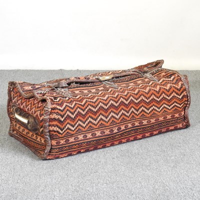 Lot 326 - A large Caucasian carpet bag, with leather...