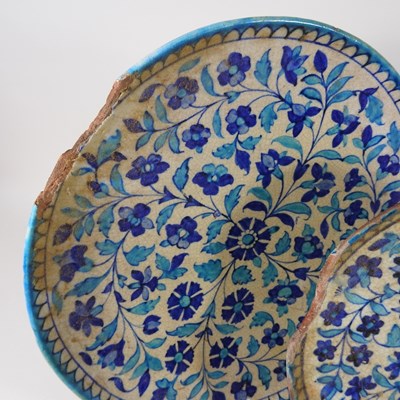 Lot 30 - A Persian iznik tin glazed dish, 38cm diameter,...