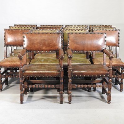 Lot 392 - A set of fourteen oak and leather upholstered dining chairs