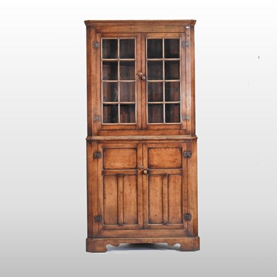 Lot 395 - A large oak standing corner cabinet