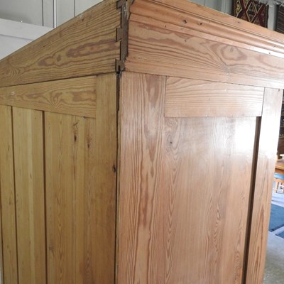 Lot 194 - A pine triple wardrobe, with two drawers below