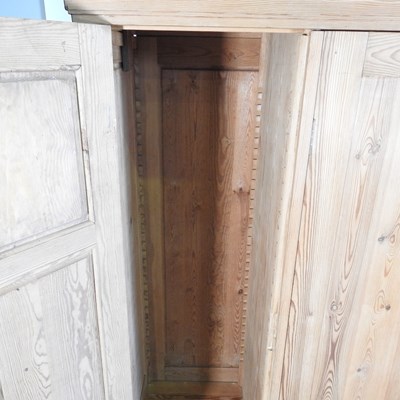 Lot 194 - A pine triple wardrobe, with two drawers below