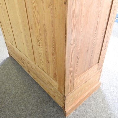 Lot 194 - A pine triple wardrobe, with two drawers below