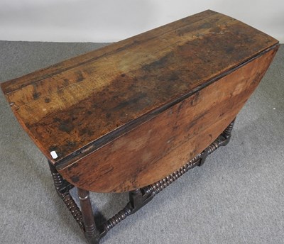 Lot 301 - An 18th century oak gateleg table, with a...