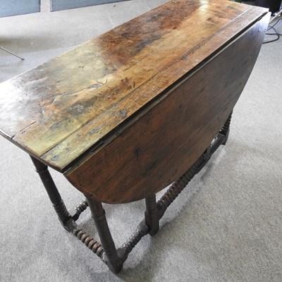 Lot 301 - An 18th century oak gateleg table, with a...