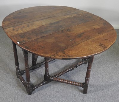 Lot 301 - An 18th century oak gateleg table, with a...