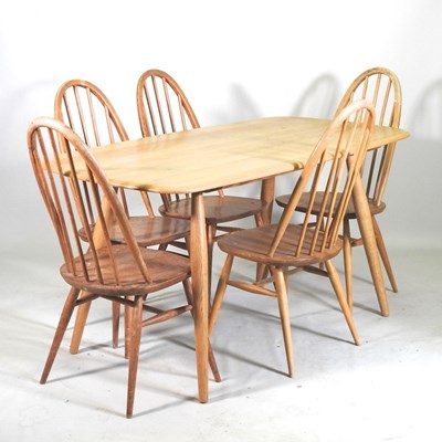 Lot 324 - A 1970's Ercol light elm dining table,...