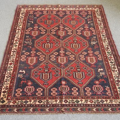 Lot 37 - A Persian kilim, with six central medallions,...