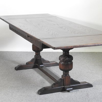 Lot 525 - A mid 20th century oak draw leaf dining table,...