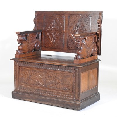 Lot 289 - An early 20th century carved oak monk's bench,...