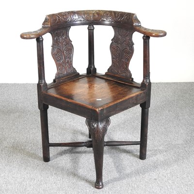 Lot 571 - A George III and later carved oak corner chair