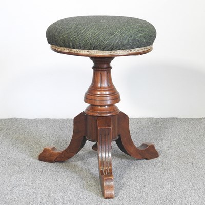 Lot 649 - A Victorian walnut revolving piano stool,...