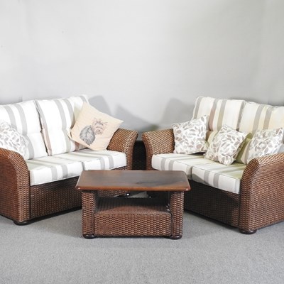 Lot 692 - A pair of MGM woven rattan sofas, with...