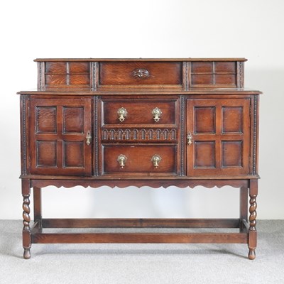 Lot 671 - A 1920's Jacobean revival oak sideboard, on...