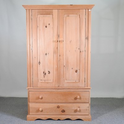 Lot 710 - A modern pine double wardrobe, with drawers below