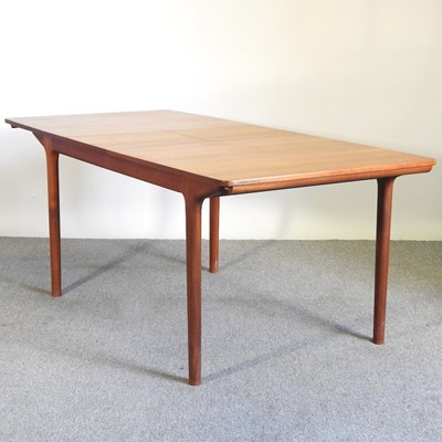 Lot 690 - A 1970's teak extending dining table, with two...