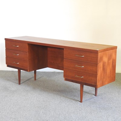 Lot 473 - A 1970's teak desk, containing six short drawers