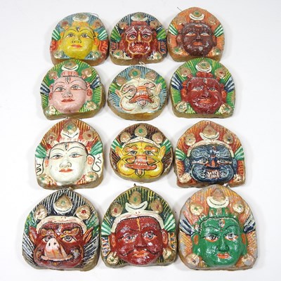 Lot 853 - A set of twelve Nepalese painted plaster faces...