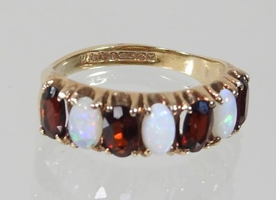 Lot 14 - A 9 carat gold garnet and opal cluster ring