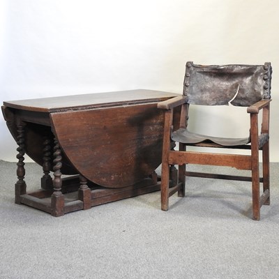 Lot 571 - A large oak gateleg dining table