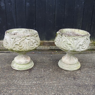 Lot 749 - A pair of cast stone garden pots, on pedestal...