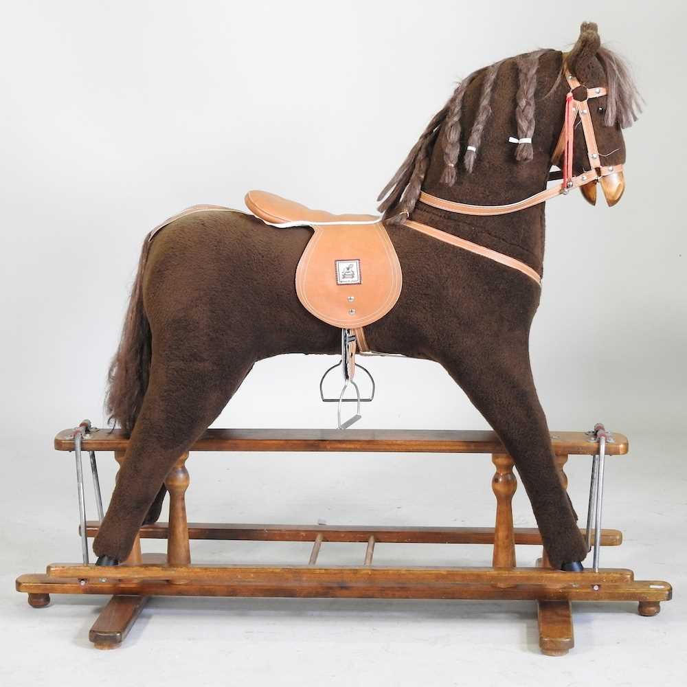 Lot 743 - A Mamas and Papas fabric rocking horse, on a...