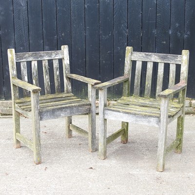 Lot 820 - A pair of teak garden arm chairs