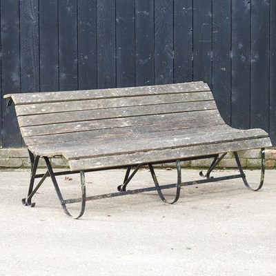 Lot 131 - A hardwood garden bench, on metal curved supports