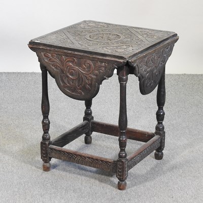 Lot 570 - A 19th century carved oak occasional table