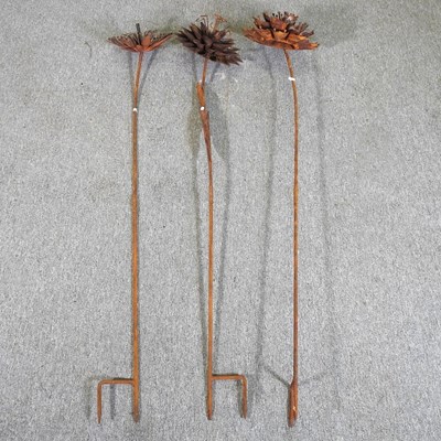 Lot 117 - A set of three rusted flower head supports (3)