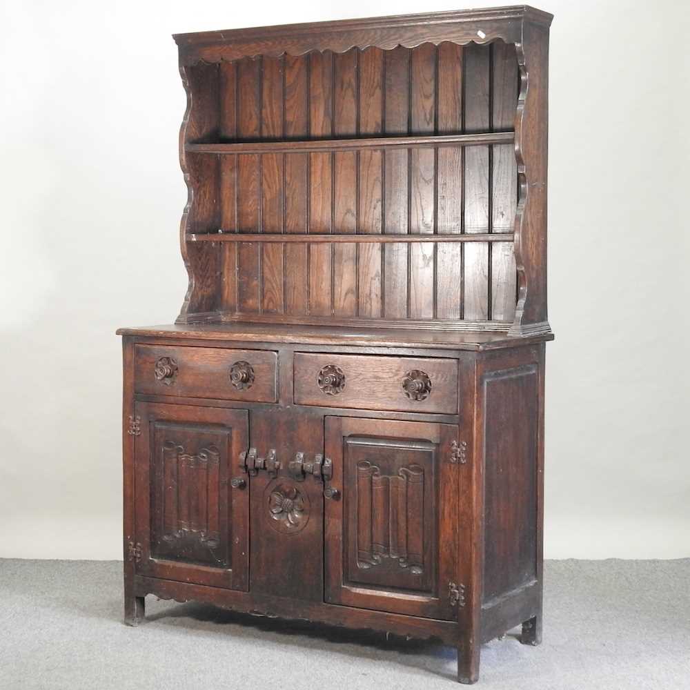 Lot 577 - An early 20th century carved oak dresser