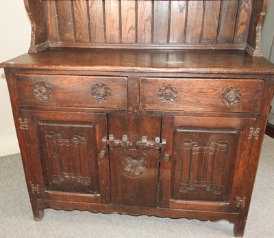 Lot 577 - An early 20th century carved oak dresser