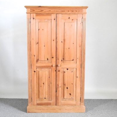 Lot 164 - A modern pine cupboard, enclosed by panelled...