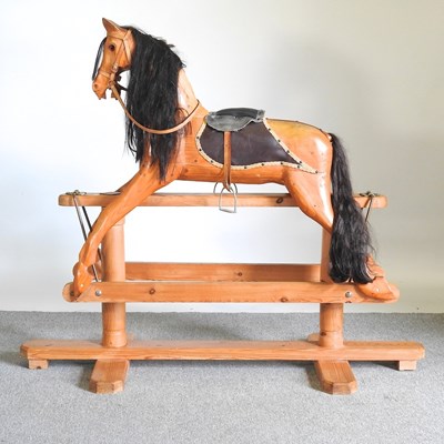 Lot 202 - A carved pine vintage rocking horse, on a...