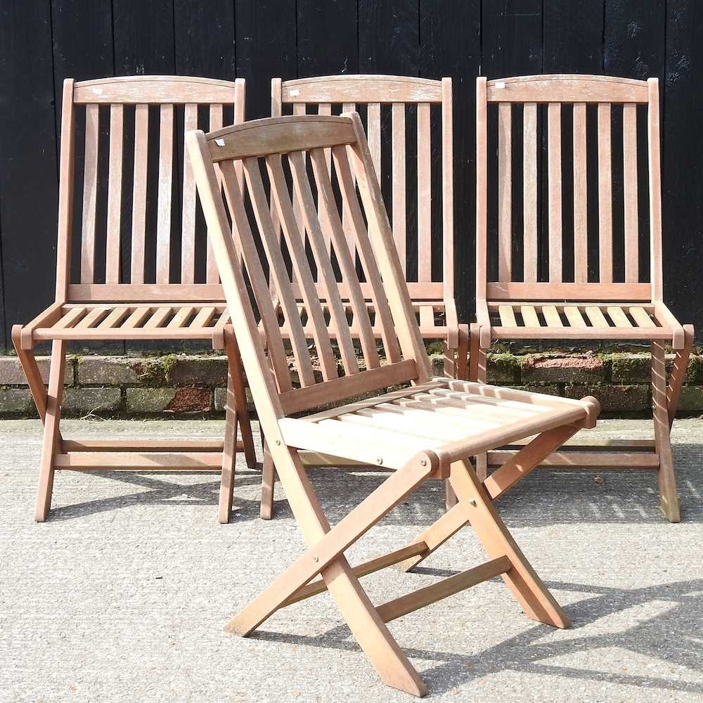 Lot 275 - A set of four teak folding garden chairs (4)