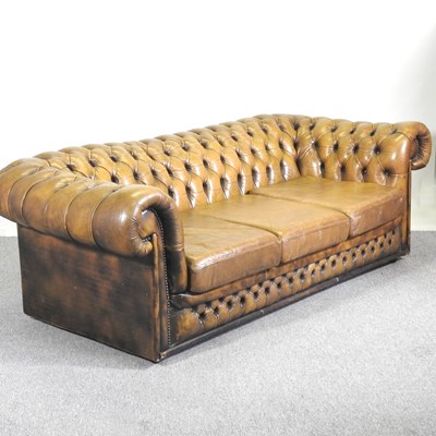 Lot 20 - A leather upholstered chesterfield sofa, with...