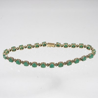 Lot 99 - A 9 carat gold emerald flexible link line...