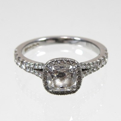 Lot 14 - A platinum and diamond halo ring, the central...