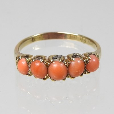 Lot 166 - An 18 carat gold coral five stone ring, 2.6g,...