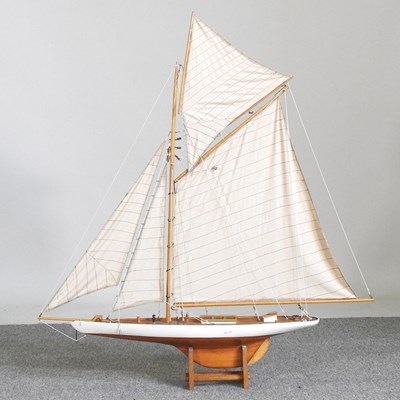 Lot 85 - A wooden model yacht, 99cm high