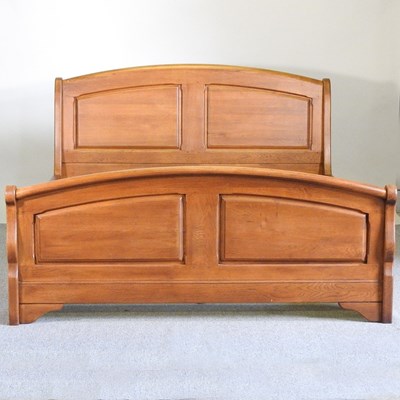 Lot 186 - A modern light oak double bed, with a slatted...