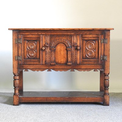Lot 294 - A 17th century style carved oak side cabinet,...