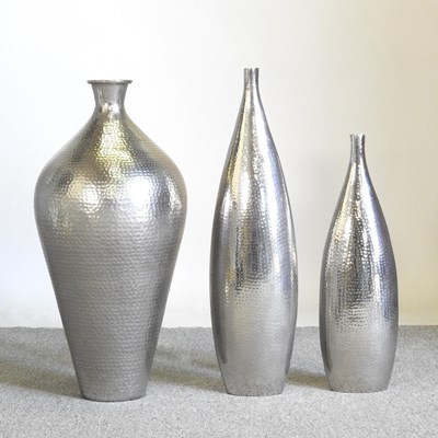 Lot 260 - A metallic vase, 77cm high. together with two...