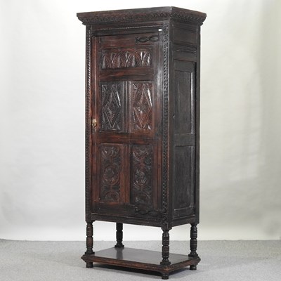 Lot 661 - A 19th century carved oak cupboard