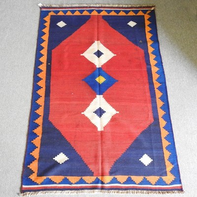 Lot 555 - A Persian qashqai kelim rug, with geometric...