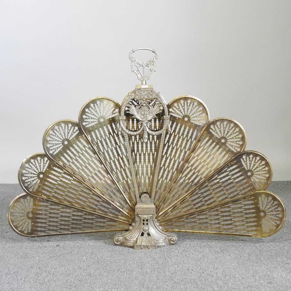 Lot 504 - A Victorian peacock fan fire screen, 68cm high