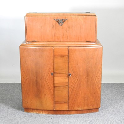 Lot 211 - A 1930's walnut drinks cabinet, with a fitted...