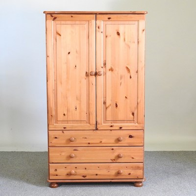 Lot 276 - A pine wardrobe, with three long drawers below