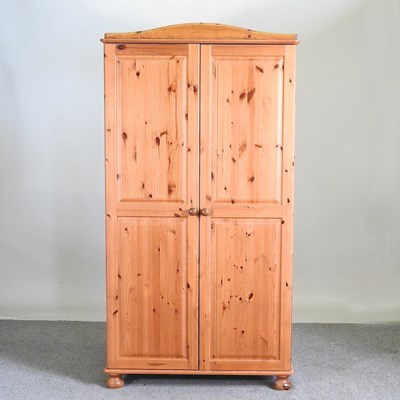 Lot 184 - A modern pine double wardrobe, on turned feet