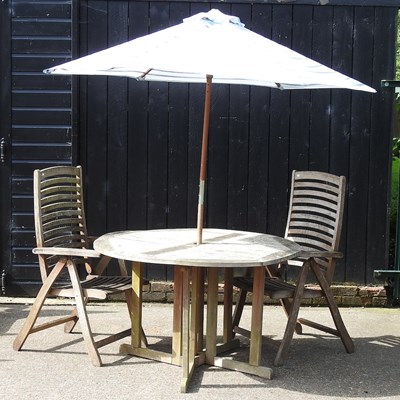 Lot 157 - A teak circular drop leaf garden table, 123cm...